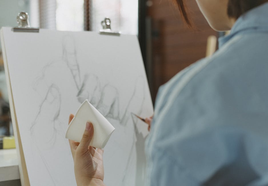 Close-up of an artist sketching hands on canvas in a Tokyo studio. Creative focus.